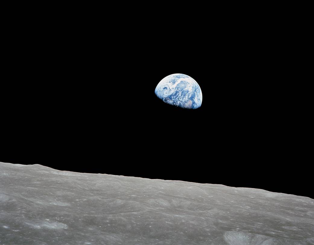 Apollo 8's Earthrise photograph showing the blue-and-white Earth rising above the lunar horizon in December 1968.