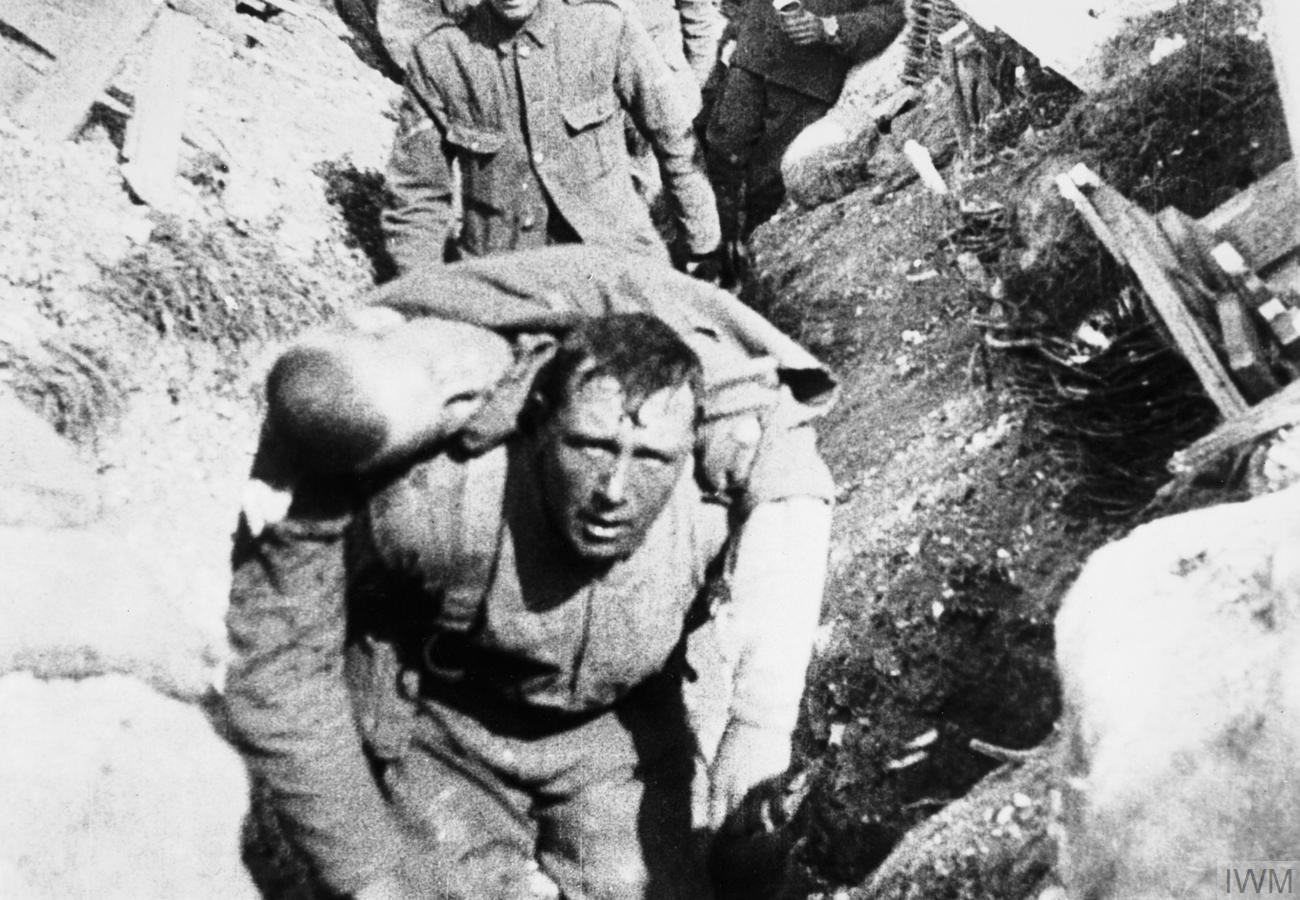 Still from The Battle of the Somme showing a British soldier carrying a wounded comrade away from the front.