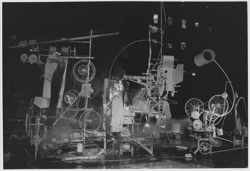 Black-and-white archival photograph of Jean Tinguely's Homage to New York assembled in MoMA's sculpture garden in 1960.