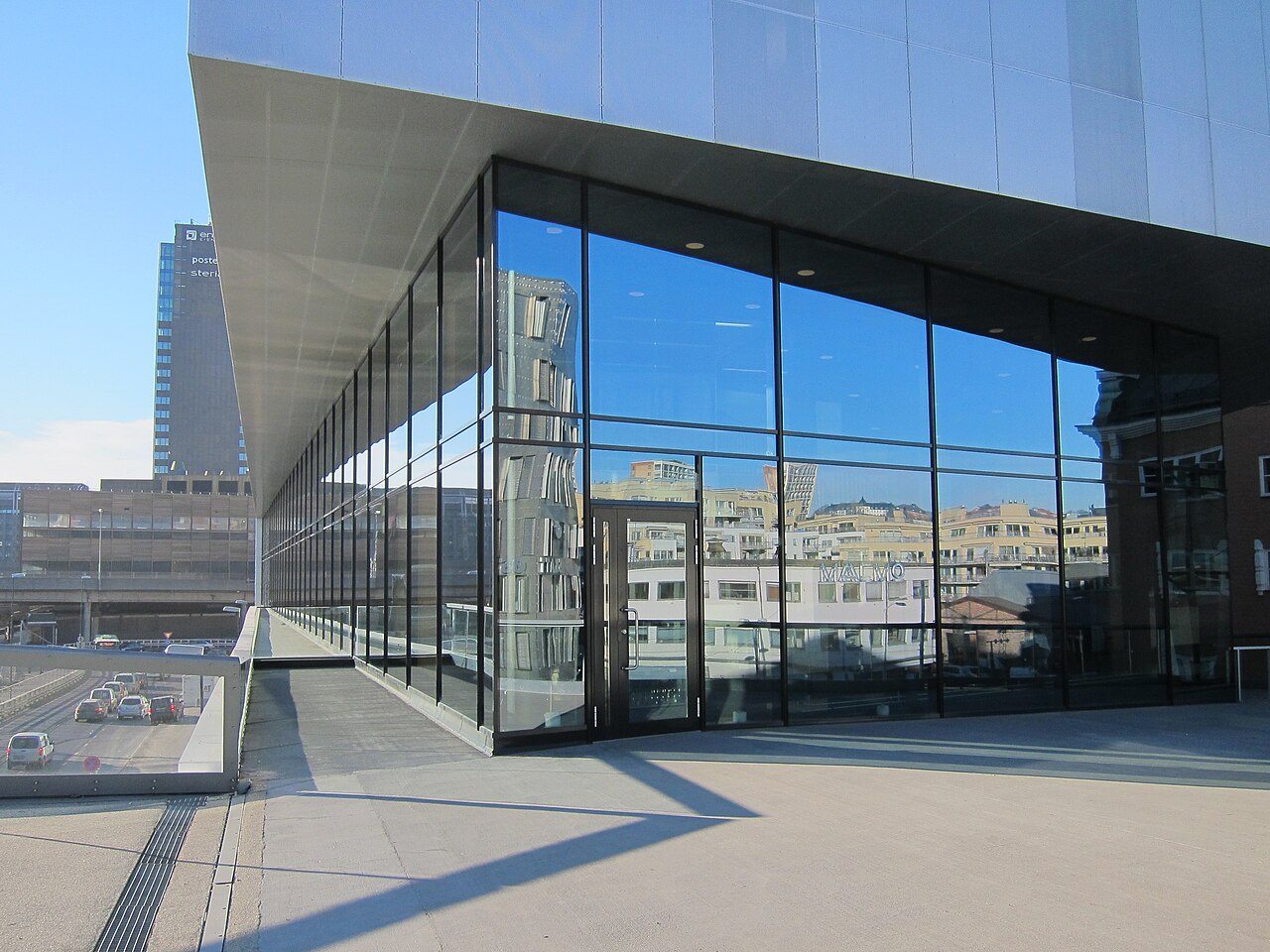 The restaurant Maaemo in Oslo, photographed from the street with its glass-fronted facade lit in the evening.