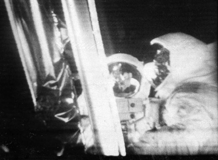 A slow-scan Apollo 11 television image showing Neil Armstrong near the lunar module ladder, photographed from a monitor at the Sydney video switching center.
