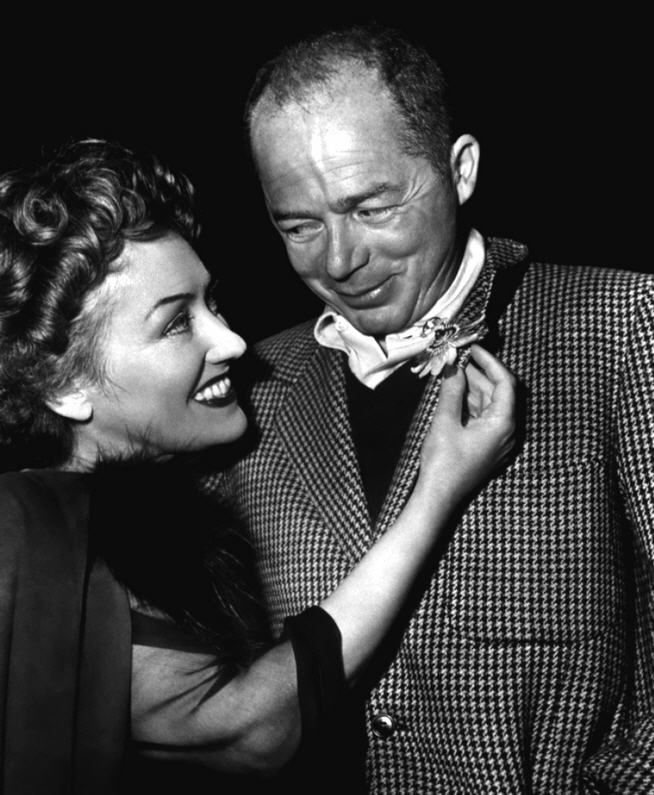 Studio publicity photo from around 1950 showing Gloria Swanson seated beside director Billy Wilder.