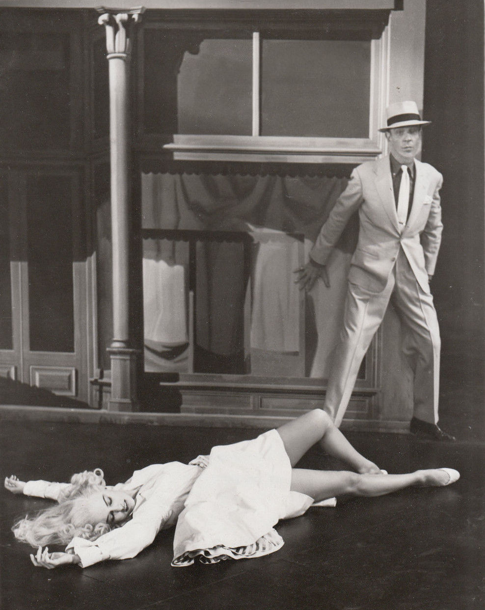 Fred Astaire standing over Cyd Charisse in a black-and-white publicity still from The Band Wagon's Girl Hunt ballet.