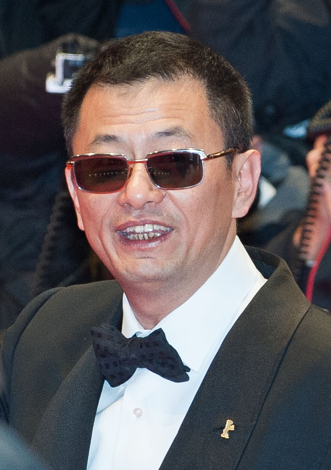 Wong Kar-wai wearing dark sunglasses and a scarf at the Berlin Film Festival.