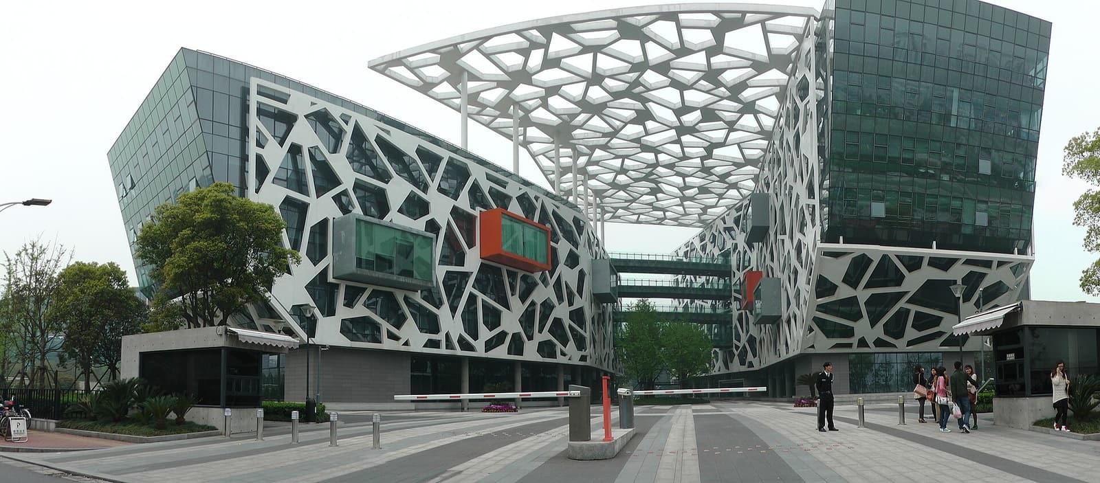 Alibaba Group headquarters in Hangzhou, photographed from across a reflecting pool.