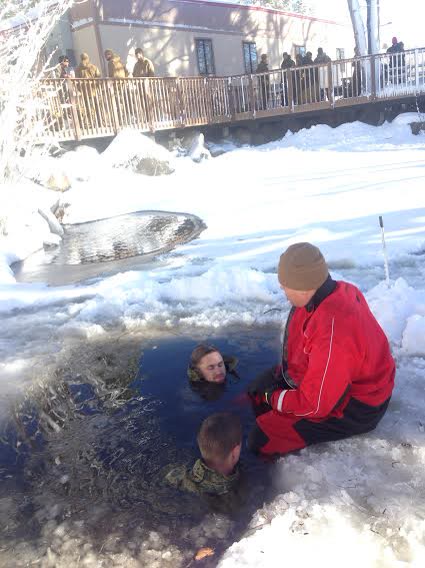 A documentary training photograph shows Marines standing in icy water during a hypothermia and rewarming exercise.