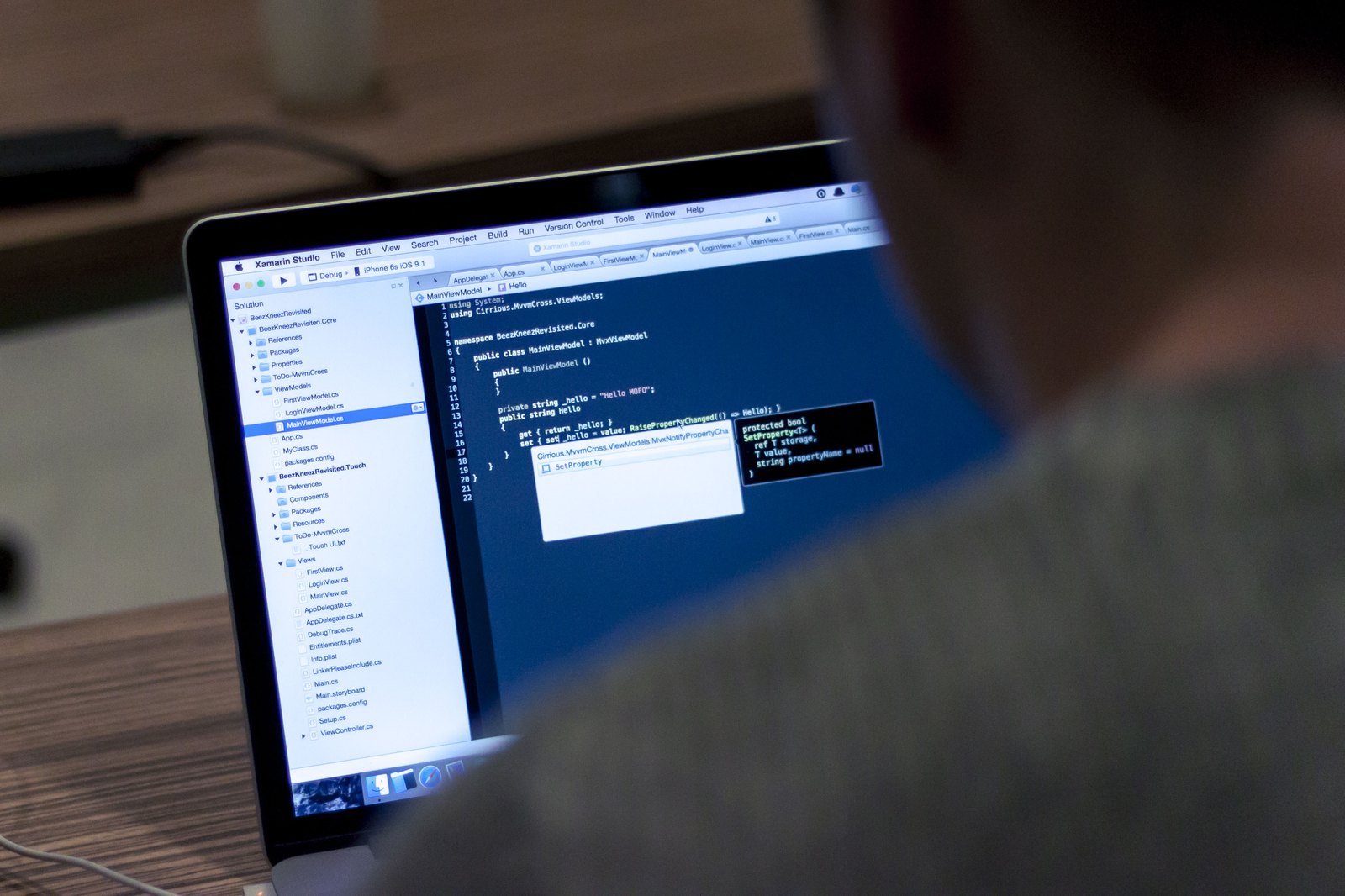 A developer workstation with a code editor and terminal panes open, suggesting the shell workflow where jq filters JSON into usable shapes.