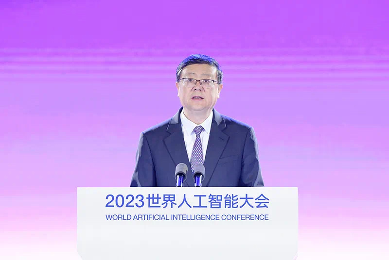 A speaker at the 2023 World Artificial Intelligence Conference in Shanghai stands behind a podium on a purple-lit stage.