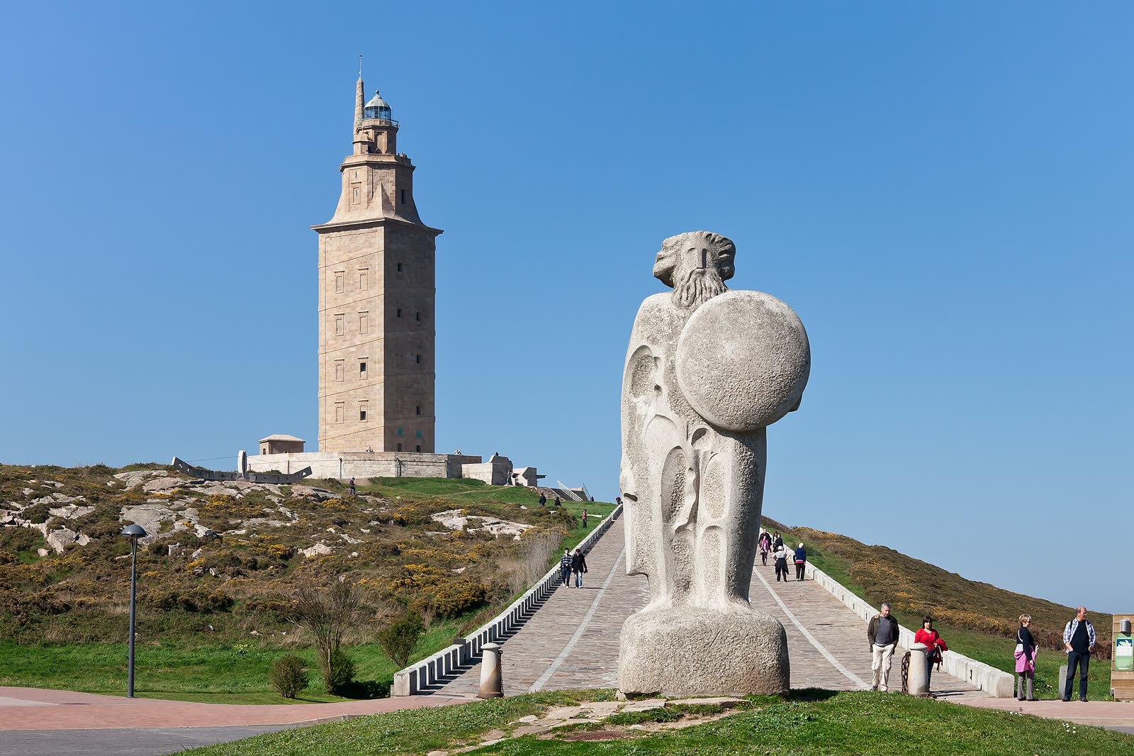 The Tower of Hercules rising above the Breogan statue and grassy Atlantic headland in A Coruna.