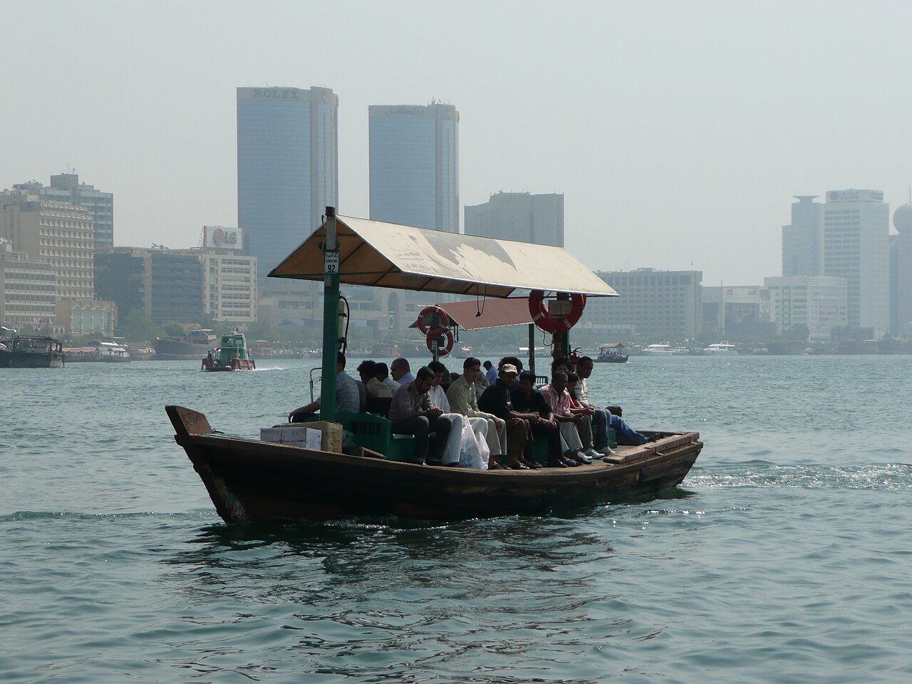 A traditional wooden abra carrying passengers across Dubai Creek.