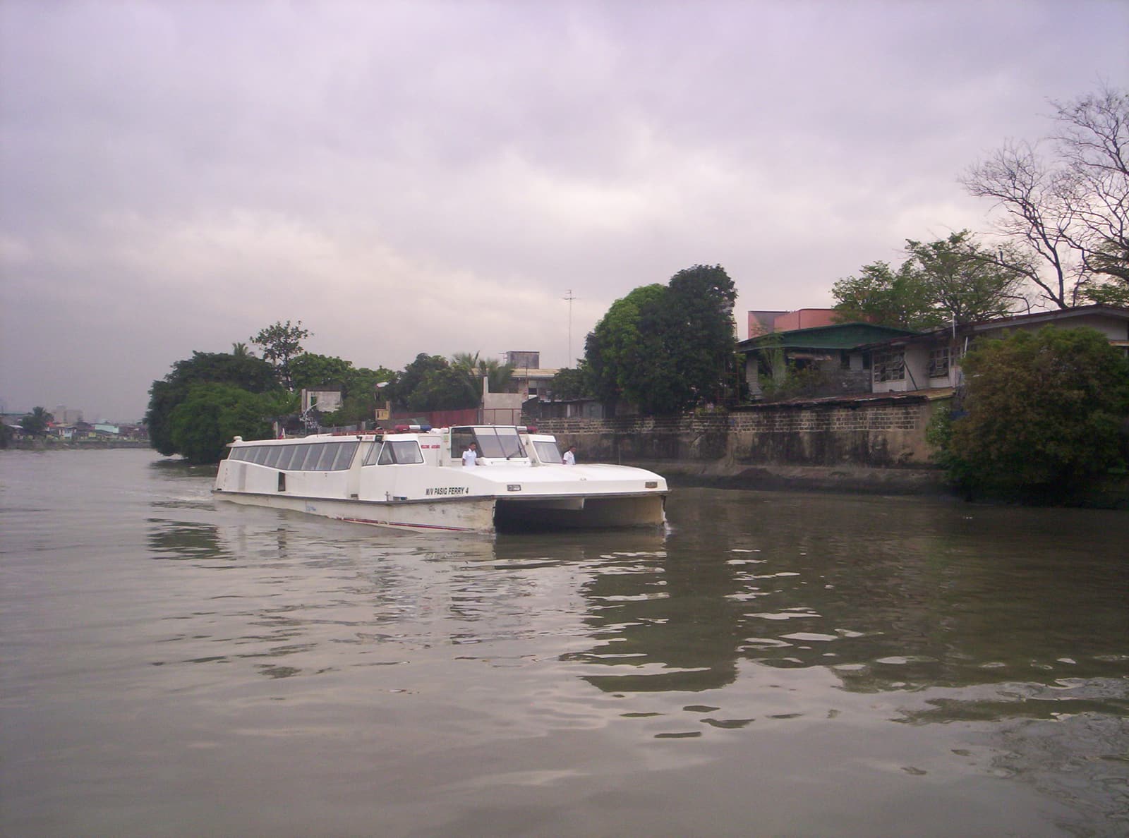 A real photograph of a Pasig River Ferry boat approaching a Manila river station.