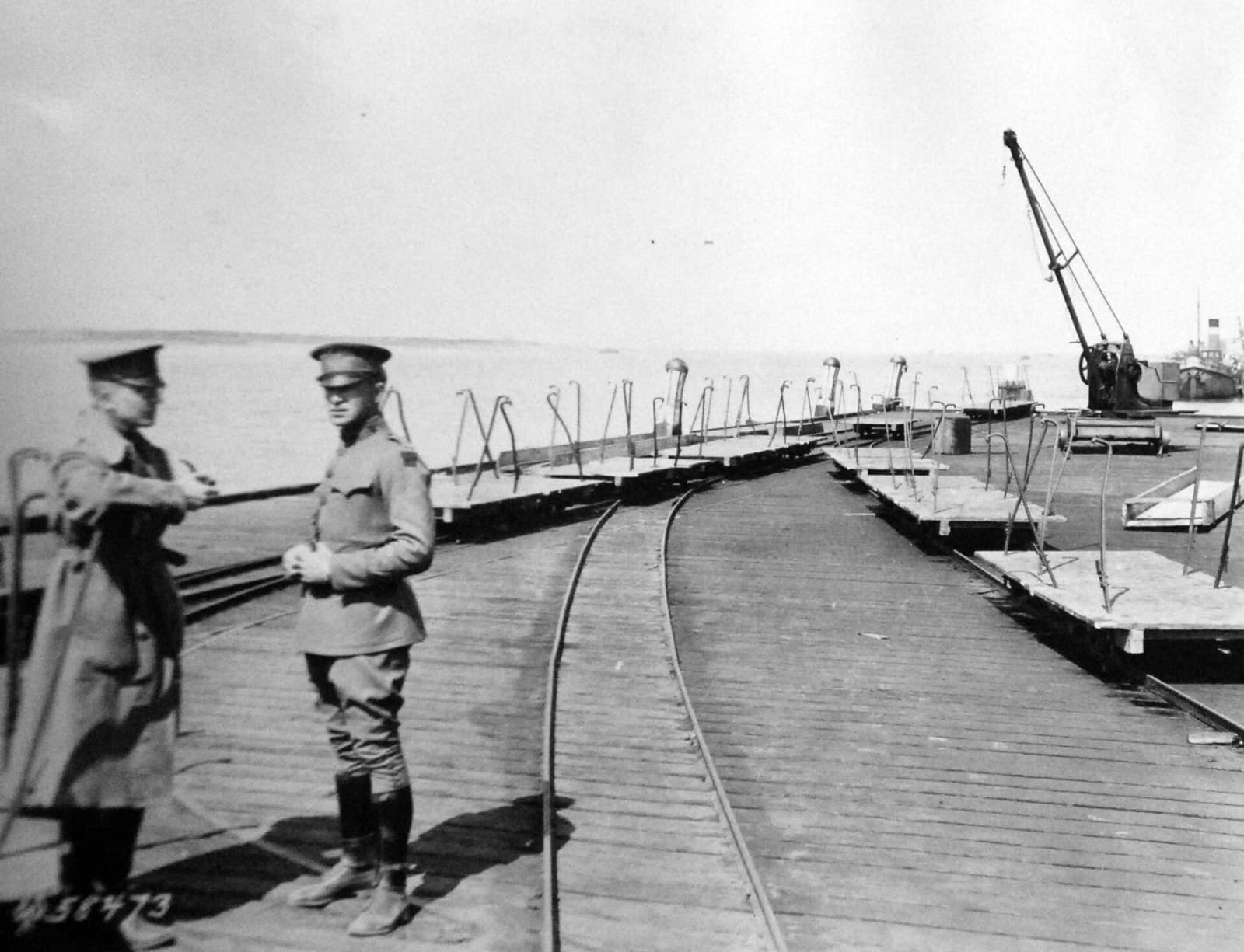 Archival photograph of workers unloading refrigerated food cargo at a dock for transfer to cold storage in 1919.