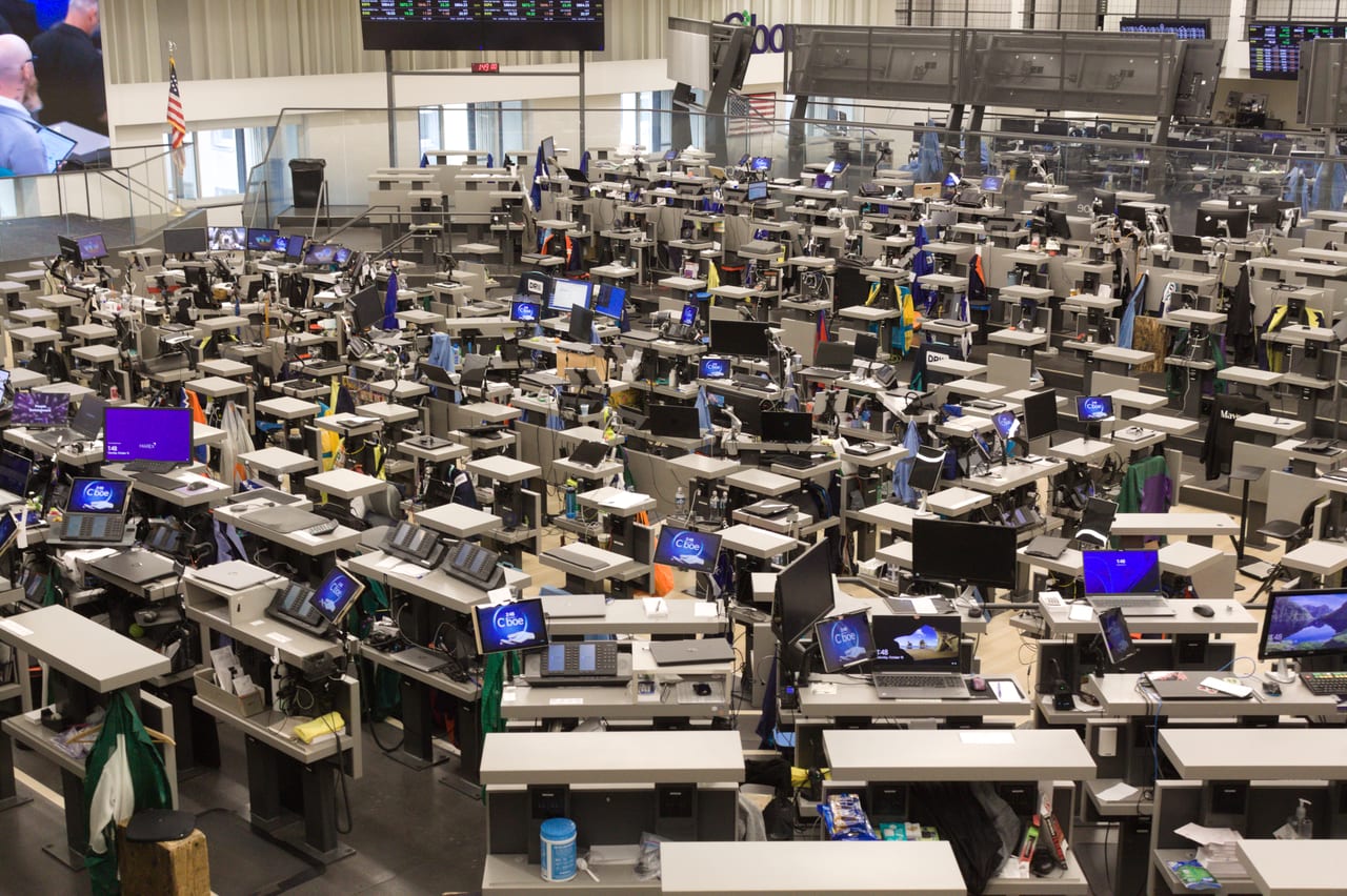 Rows of trading desks and monitors on the Chicago Board of Trade trading floor.