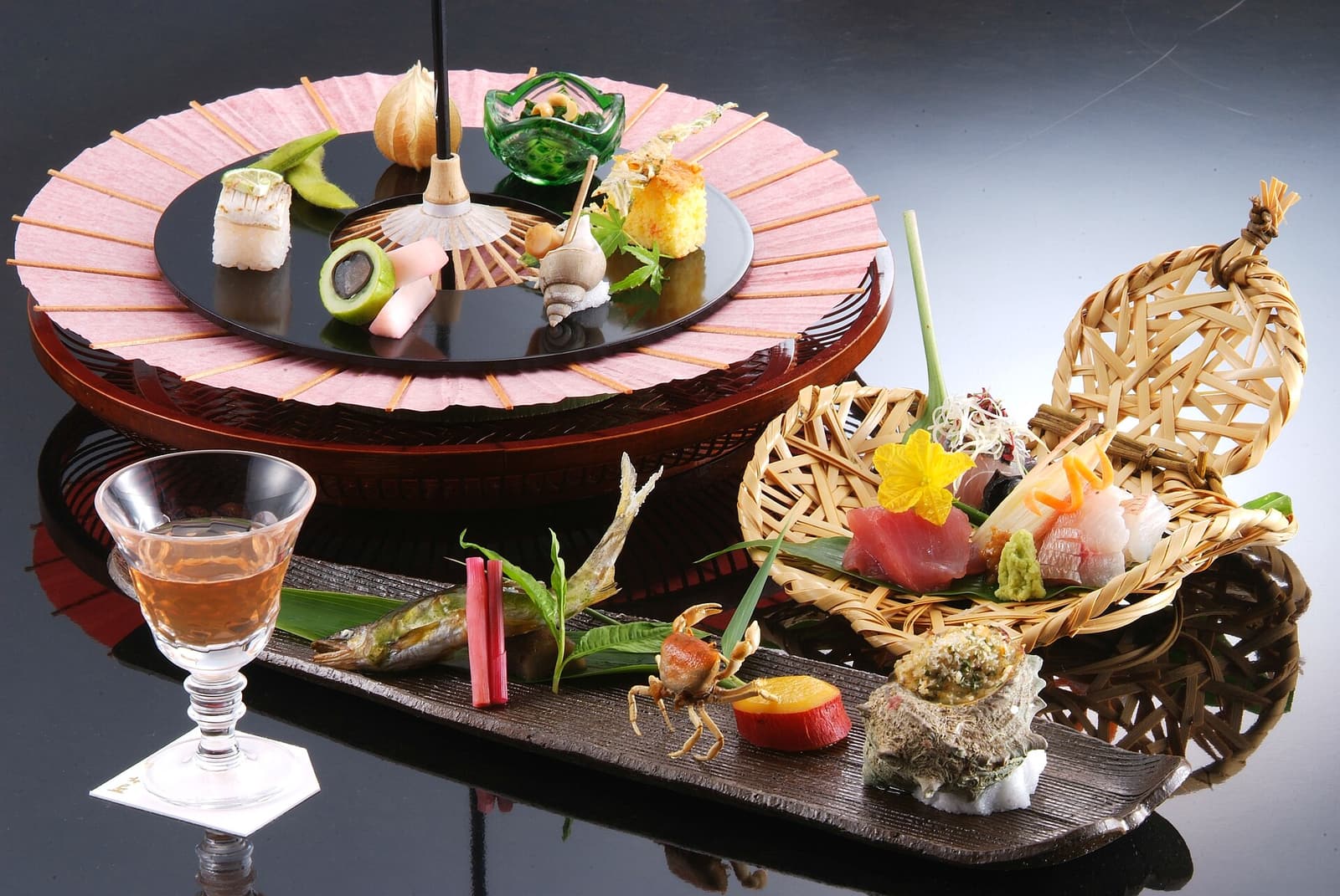 A seasonal kaiseki meal arranged in small dishes at Nishimuraya Honkan in Kinosaki Onsen.
