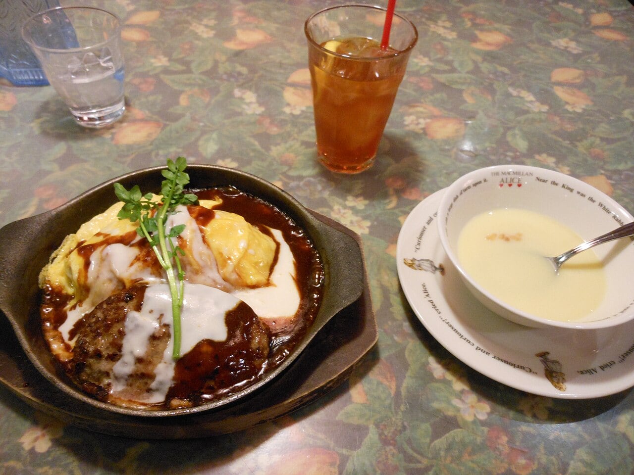 Creamy egg omurice served with a glossy brown demi-glace sauce.