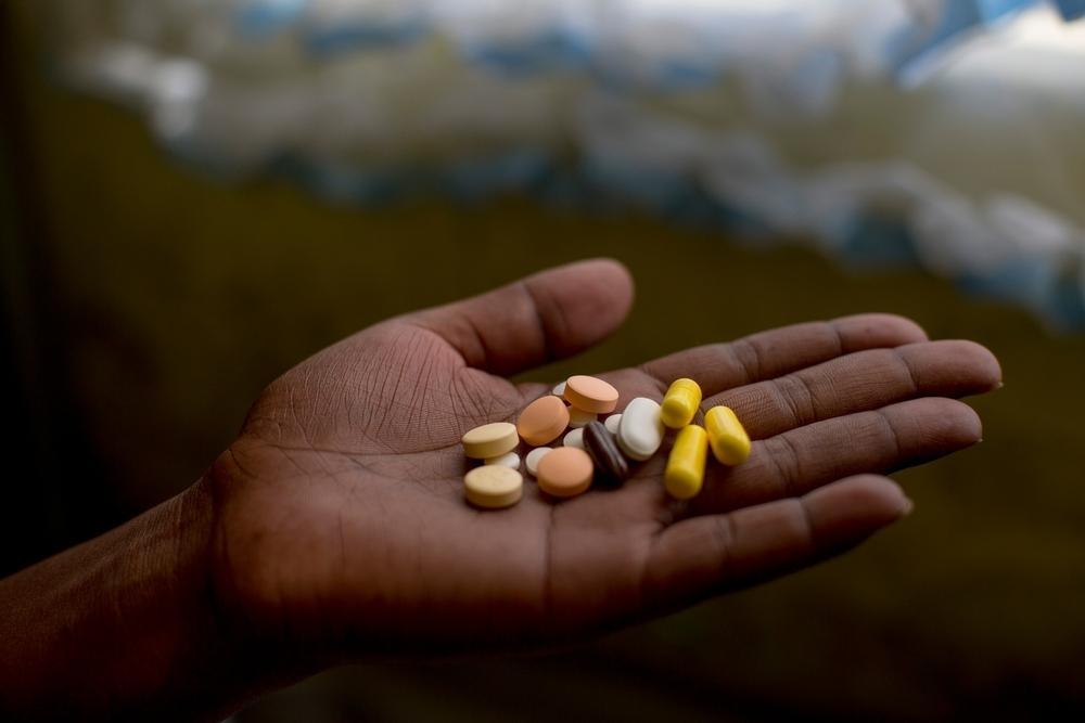 A patient in Khayelitsha, South Africa holds a multi-drug regimen for pre-XDR tuberculosis in an open hand.