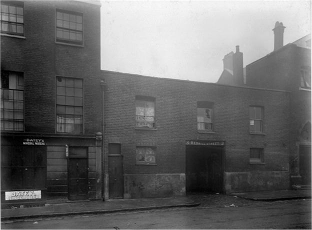 Archival photograph of a London slum street in the 1880s.