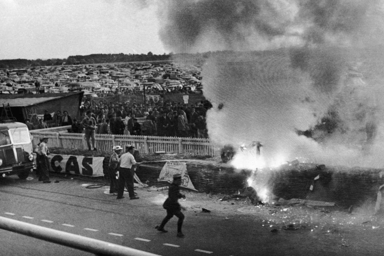 A black-and-white Associated Press photograph shows Pierre Levegh's Mercedes-Benz launching upward during the 1955 Le Mans disaster, with spectators and trackside barriers visible beyond the car.