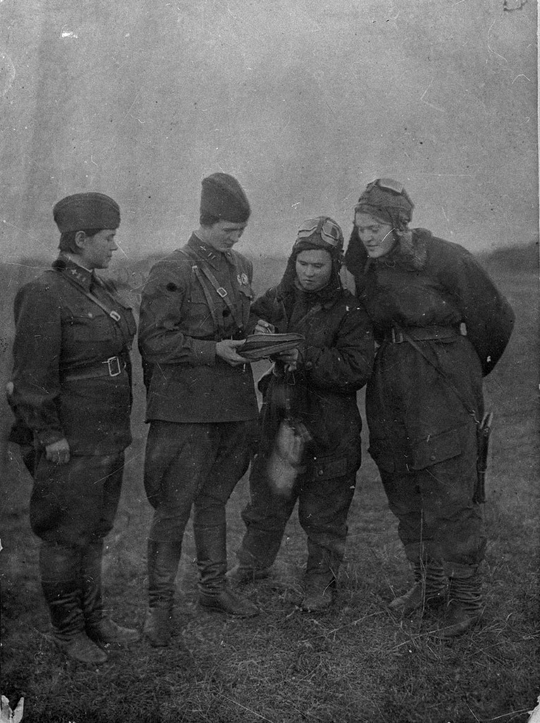 Black-and-white 1942 archival photograph of women aviators from the Soviet 588th Night Bomber Regiment standing together in military uniform.