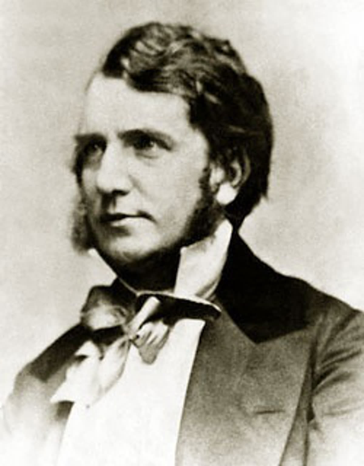 Archival portrait photograph of Sheridan Le Fanu from 1873, showing him in a dark coat and bow tie.
