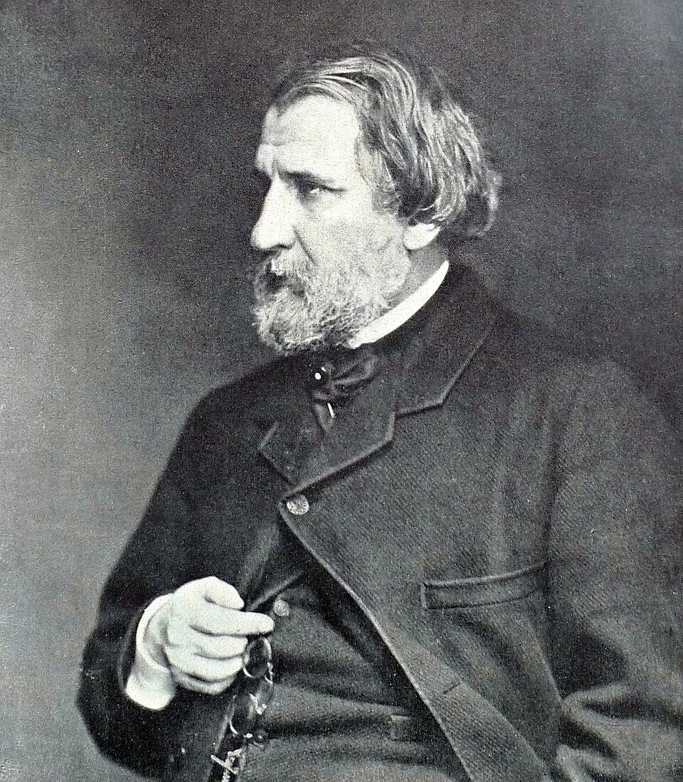 Archival 1871 photographic portrait of Ivan Turgenev in Baden-Baden, seated in a dark coat with a full beard.