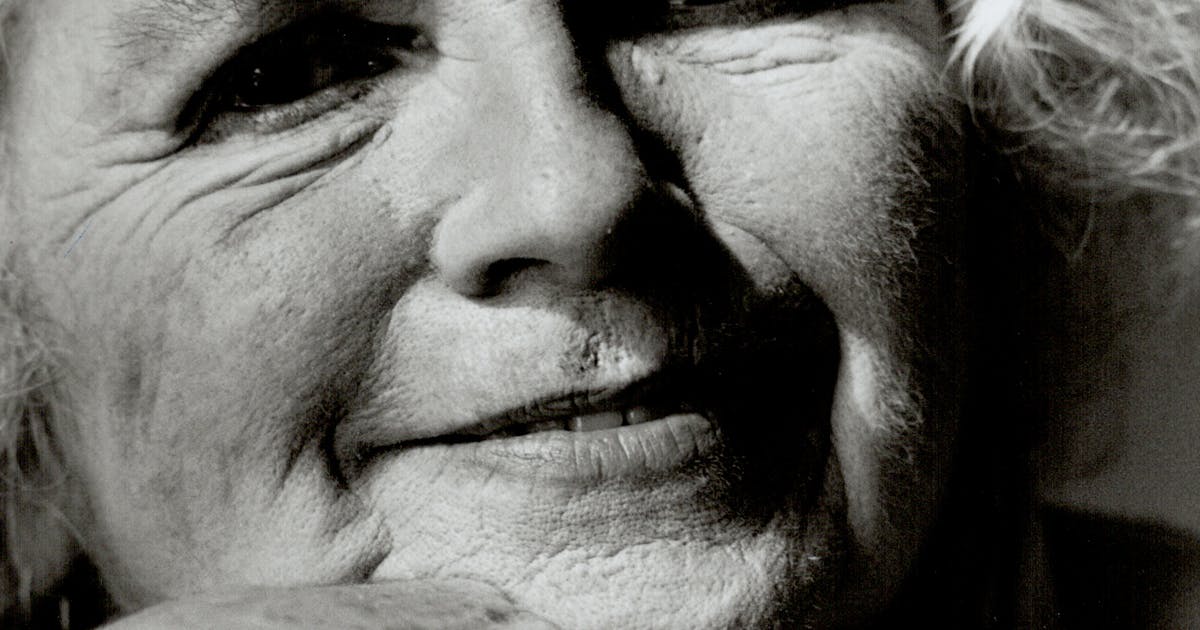 Black-and-white photographic portrait of Grace Paley resting her chin on her hand.