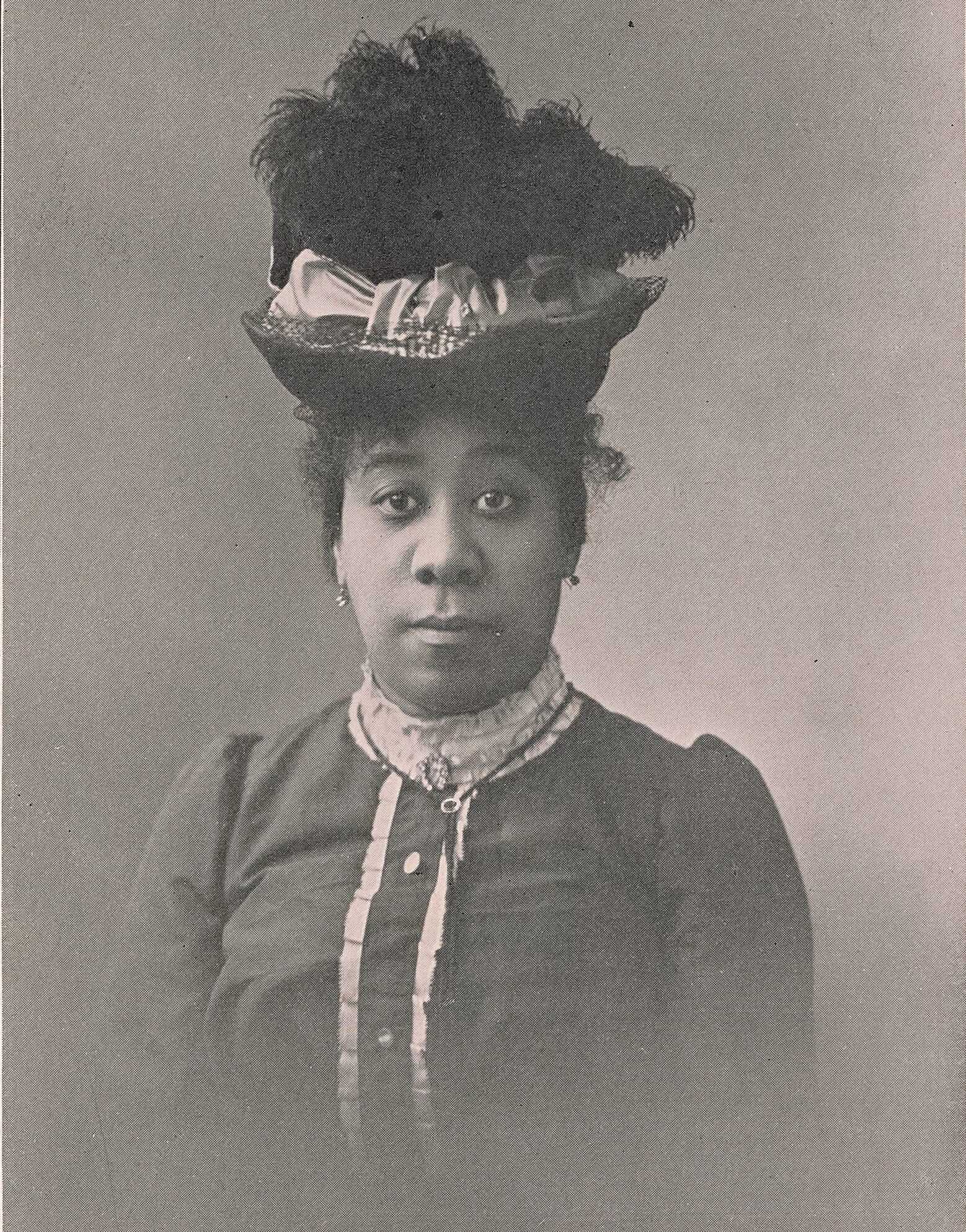Archival photographic portrait of Pauline Elizabeth Hopkins around 1900, wearing a high-crowned hat and dark dress.
