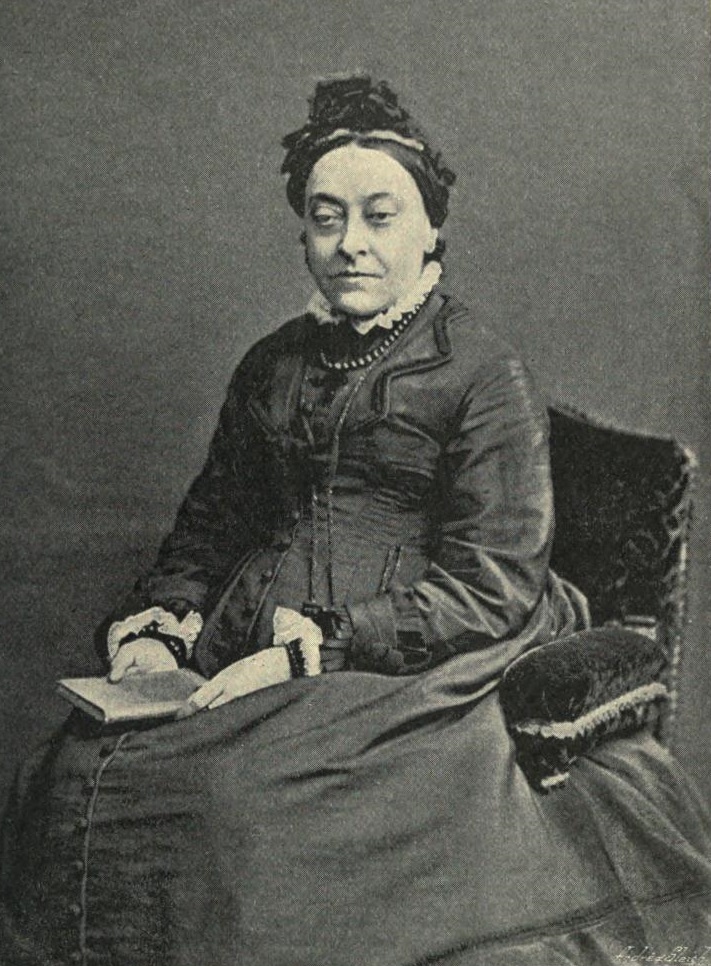 Archival photographic portrait of Christina Rossetti, facing slightly left in a dark dress.