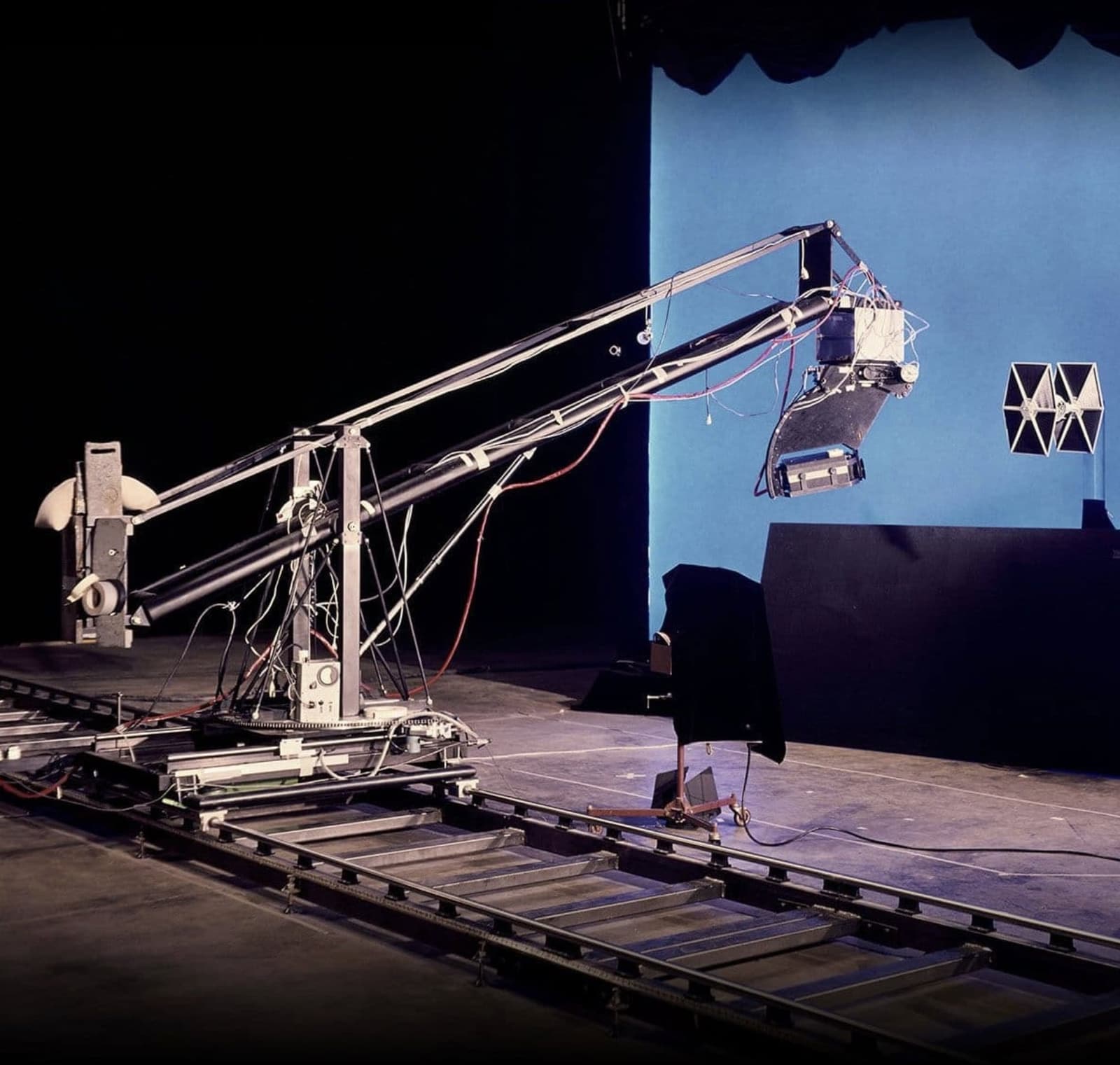 The Dykstraflex motion-control camera rig on a studio track filming a TIE fighter miniature against a blue backing.