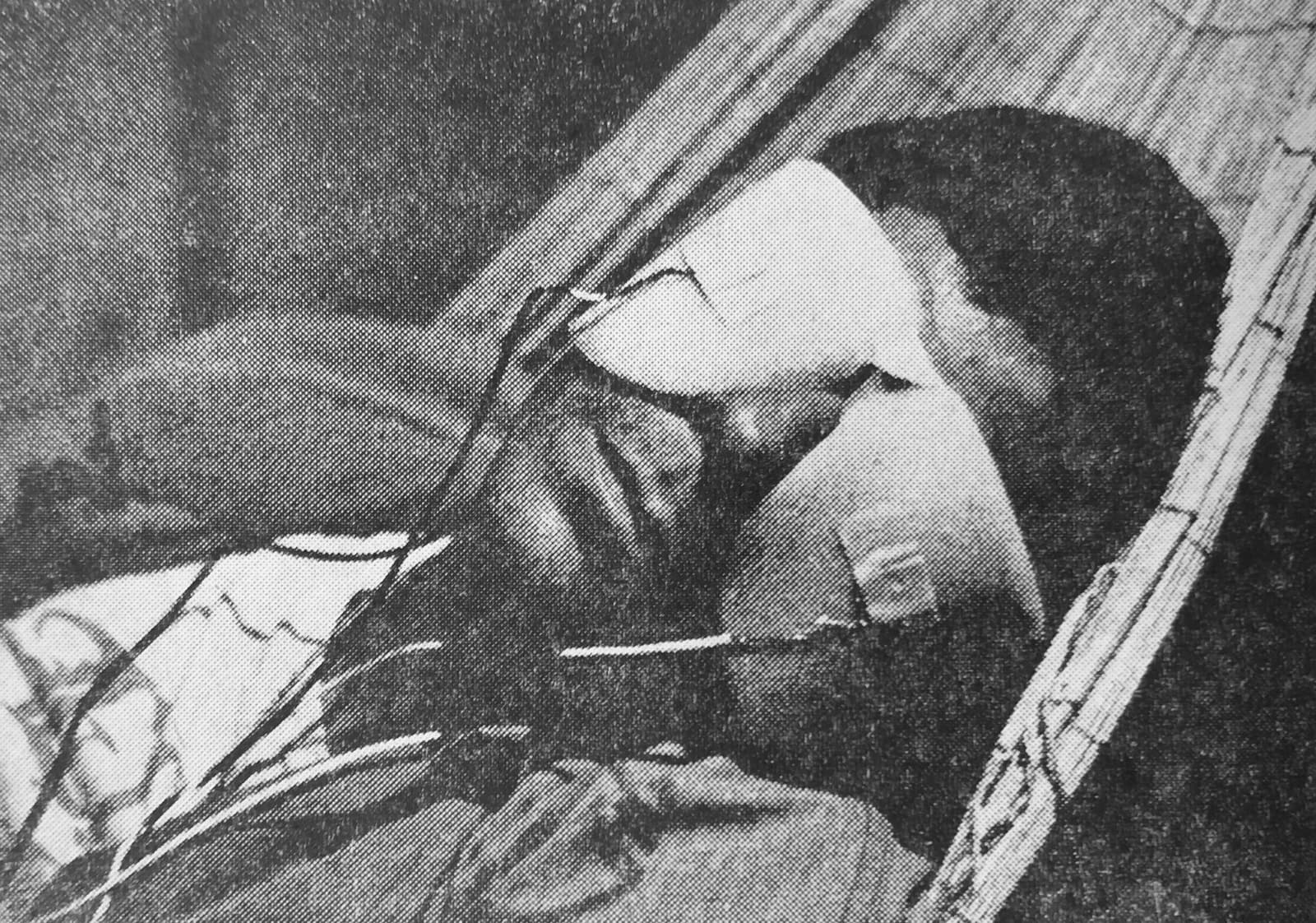 Black-and-white archival film still from La Jetee showing the time-travel subject lying with eye coverings and wires attached during the experiment.