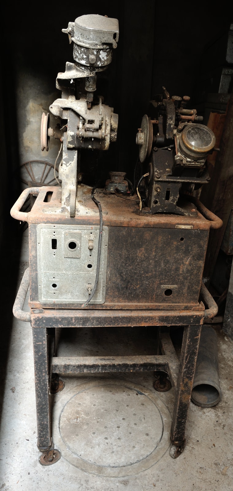 A photographed upright 35mm Moviola film editing machine with reels, viewer, control surfaces, and metal body visible.