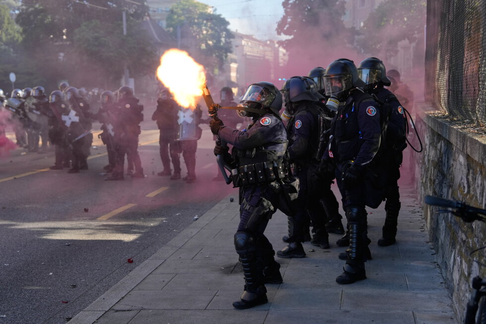 Police fire a tear gas canister during a No G7 demonstration in Geneva ahead of the Evian summit.