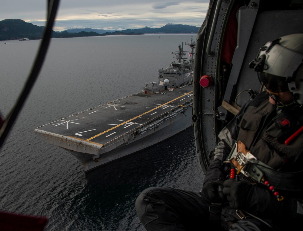 The amphibious assault ship USS Iwo Jima steams through Norway's Alvund Fjord during NATO's Trident Juncture 2018 exercise.