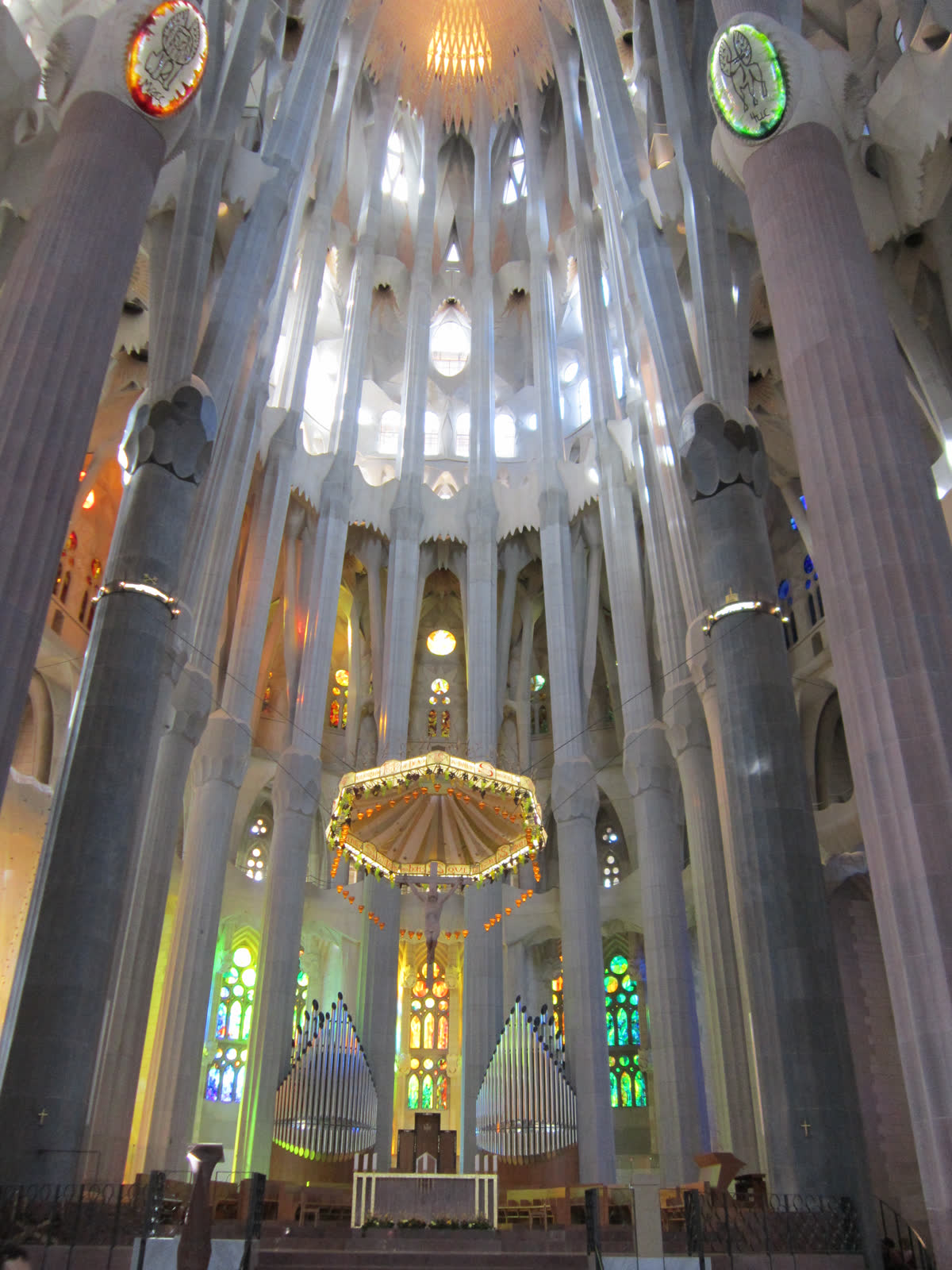 Photograph of the main altar and branching columns inside Barcelona's Sagrada Familia basilica.