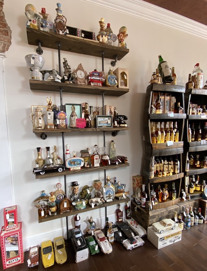 Rows of vintage liquor bottles displayed on shelves in a bottle shop.