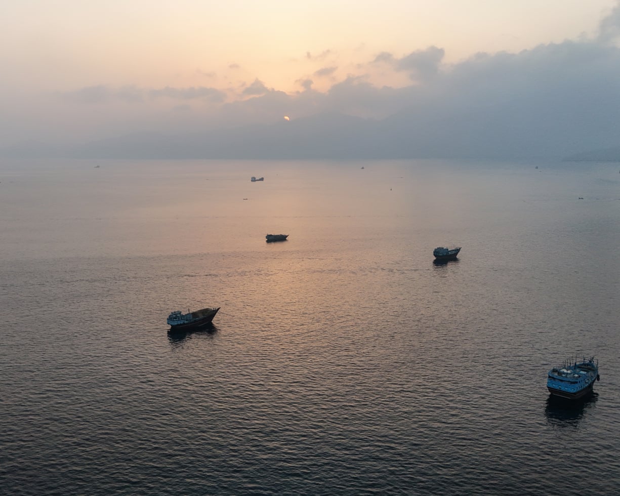 夕阳下，阿曼北部穆桑达姆半岛、霍尔木兹海峡附近锚泊的船只。