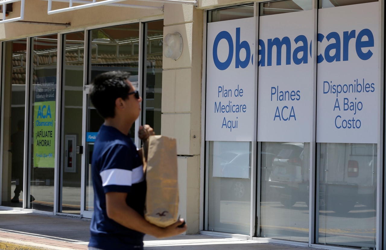 A man walks past an Obamacare health insurance office in Hialeah, Florida, in 2017.