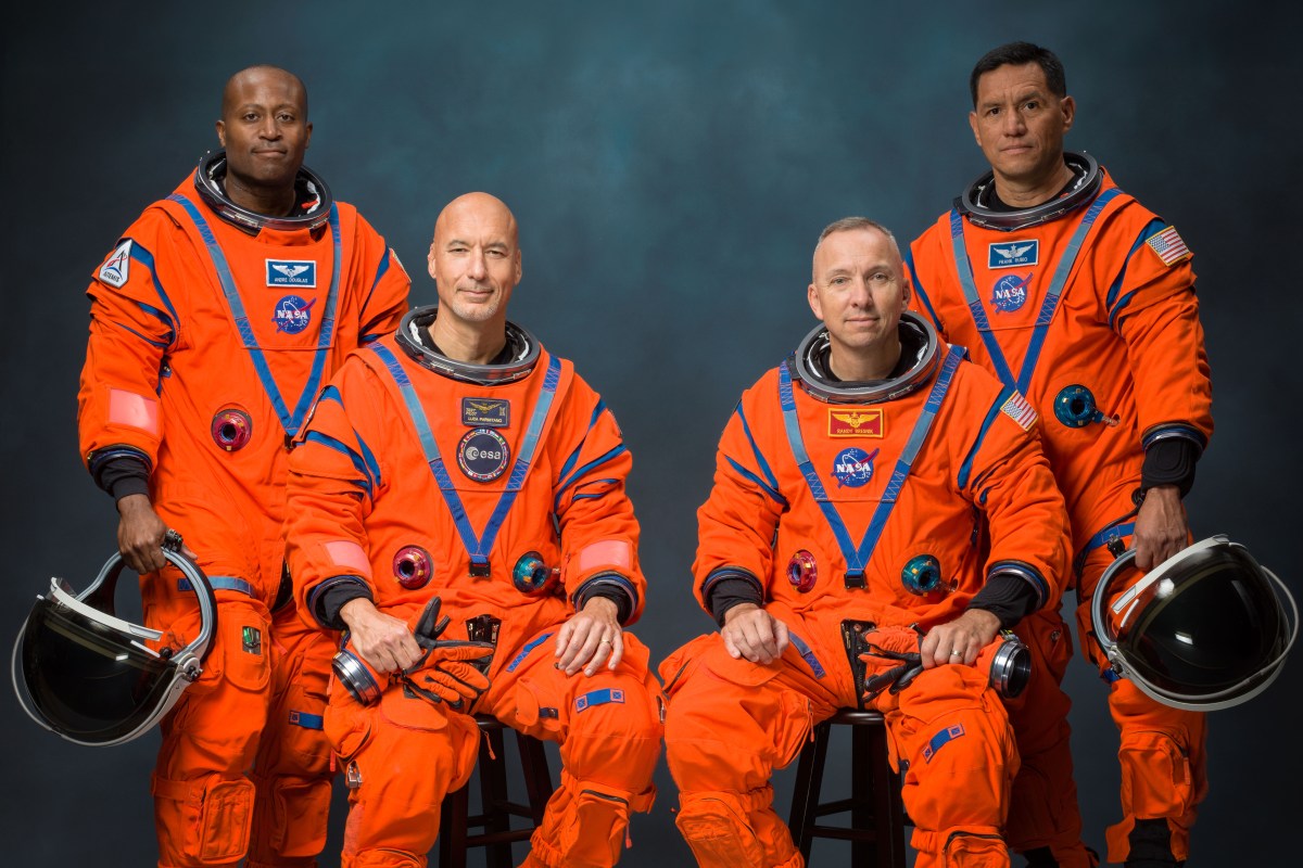NASA's Artemis III crew portrait showing Andre Douglas, Luca Parmitano, Randy Bresnik, and Frank Rubio standing together in blue flight suits.