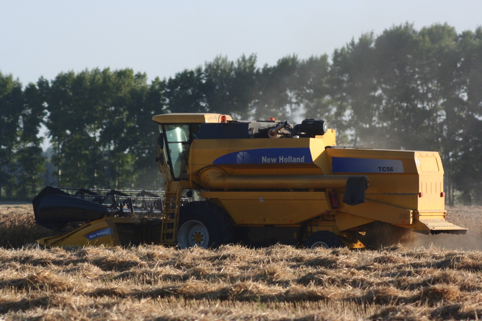 A New Holland combine harvester photographed in a field.