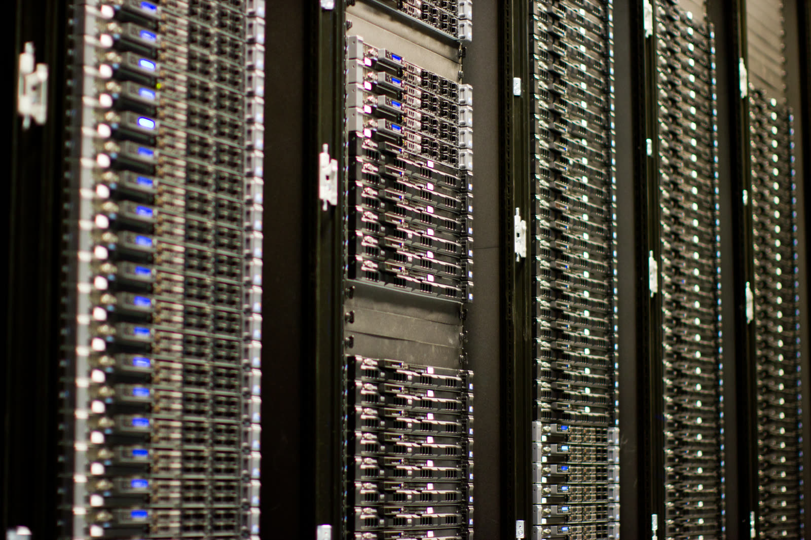 Rows of Wikimedia Foundation servers in a data center aisle, with black racks and visible cabling.
