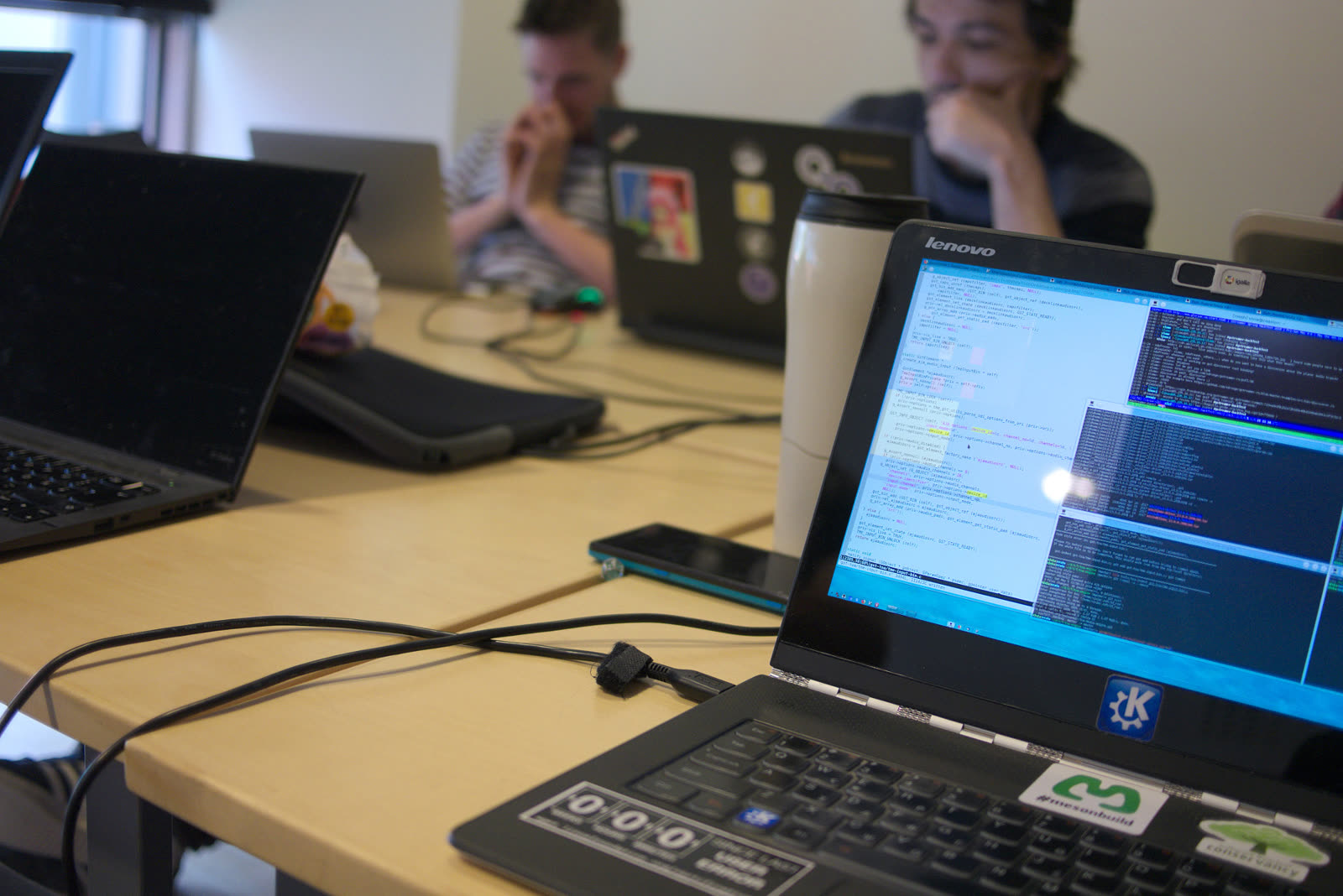 People working with laptops at a GStreamer Spring hackfest.