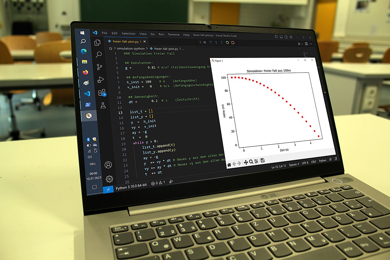 A physical lab notebook sits beside a laptop screen showing Python code in a text editor.