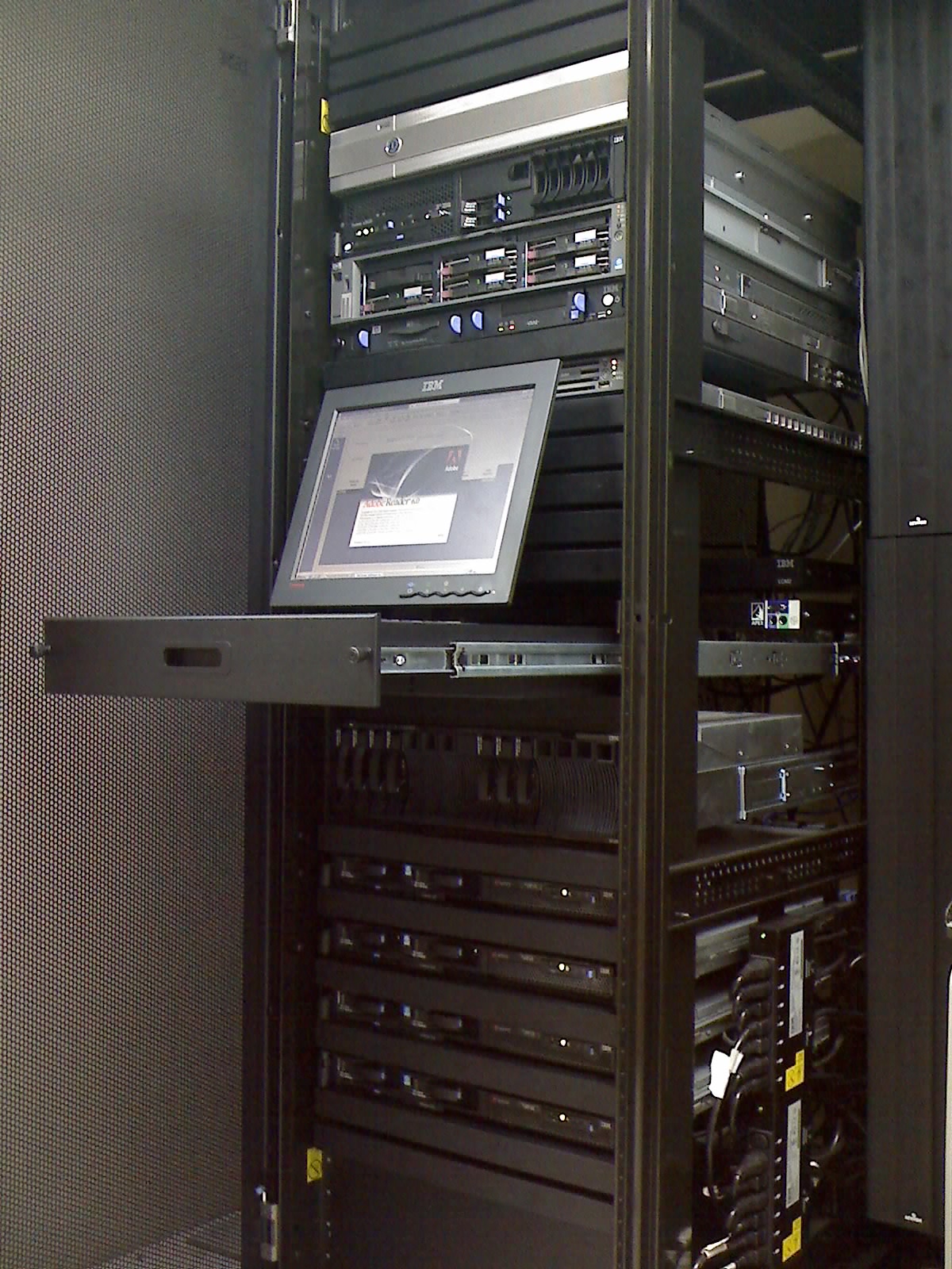 A server rack with mounted hardware and a pull-out console.