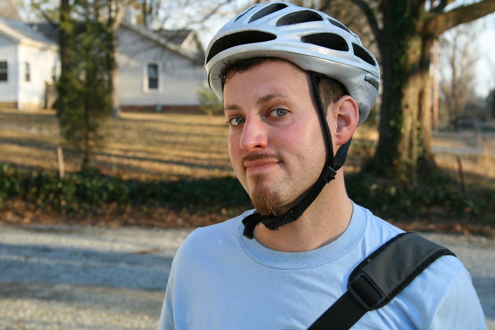 A cyclist riding through a real street scene, foregrounding the human route choices that Valhalla costing models must support.