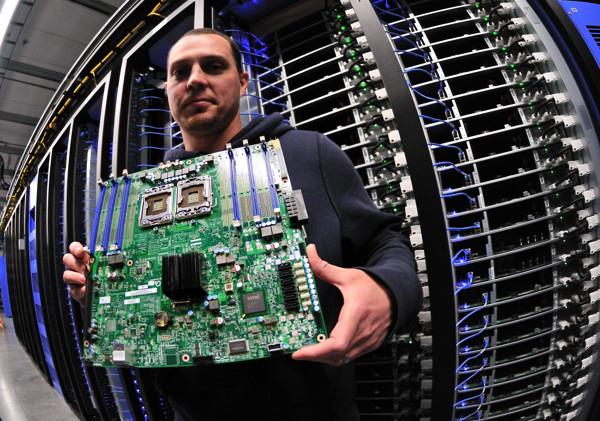 A Facebook engineer holding a data-center server board at the Prineville data center.