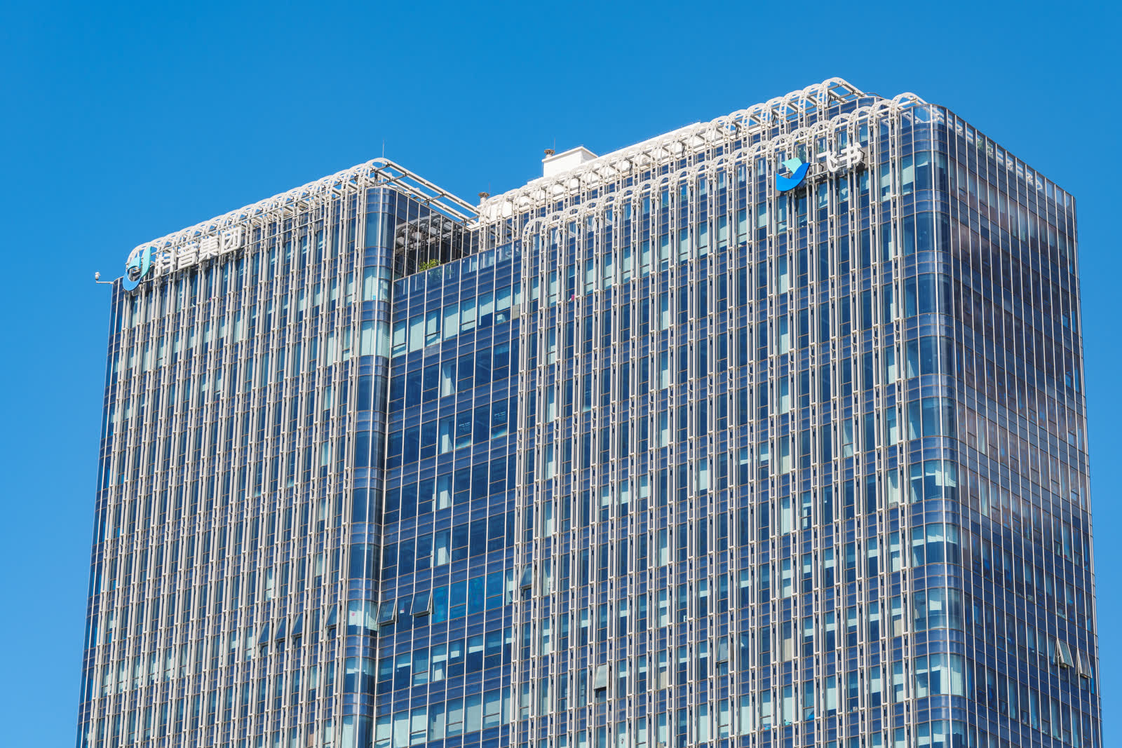 Douyin Group and Feishu logos mounted on the facade of Fashion Vanke Center.