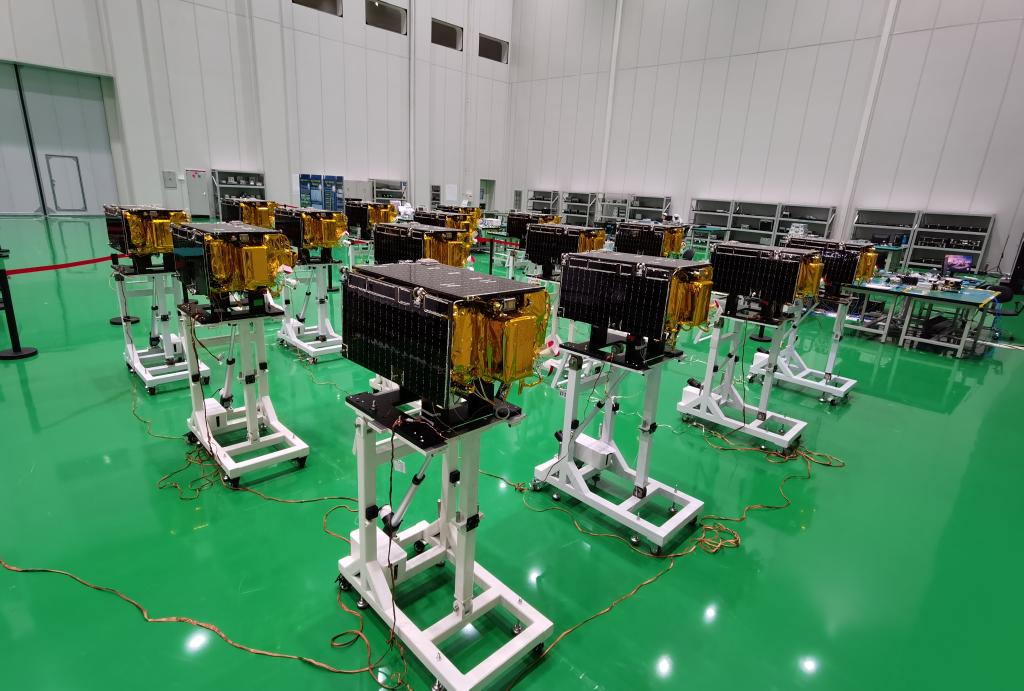 Rows of compact Jilin-1 Gaofen-03 remote-sensing satellites undergoing batch production inside a clean manufacturing hall.