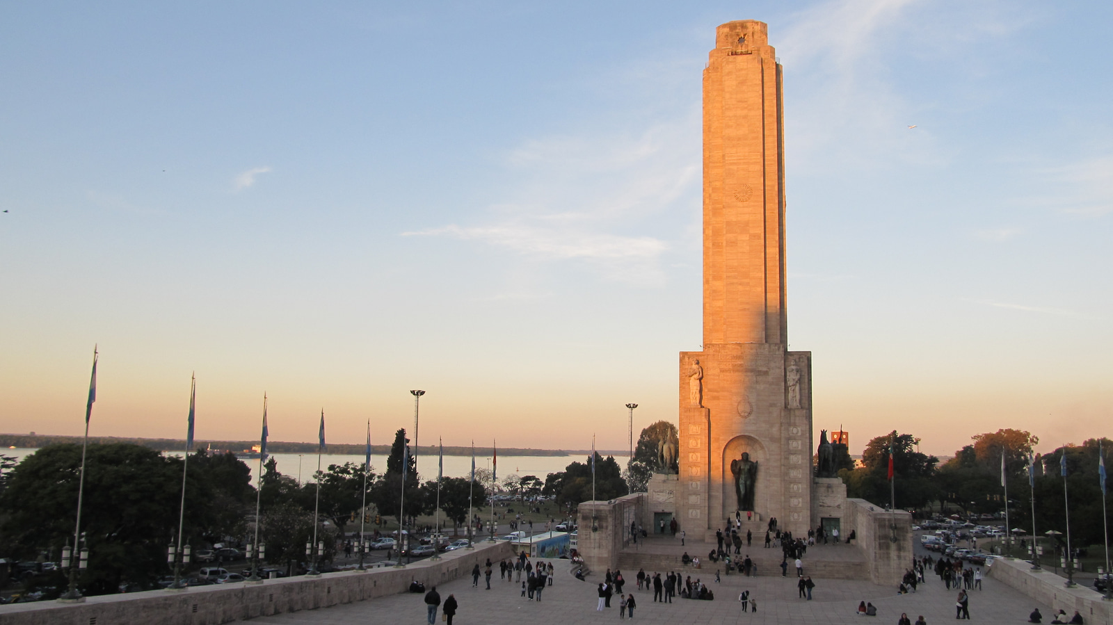 Rosario's National Flag Memorial rises above its broad civic steps, with the tower, stone wings, and open forecourt visible under a blue sky.