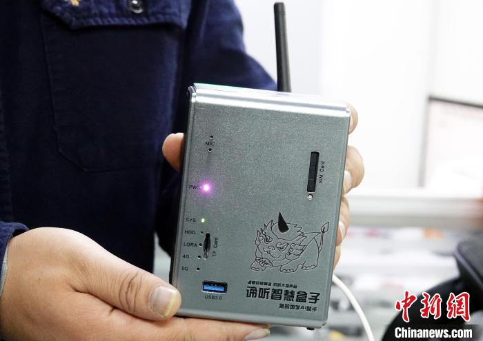 Two hands hold a compact silver DiTing Smart Box with antenna, status lights, ports, and the project's listening-beast emblem.