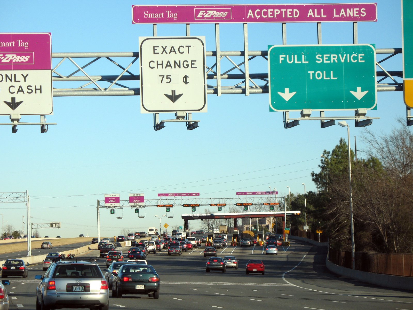 Cars passing through the main toll plaza on the Dulles Toll Road in Virginia shortly before rush hour.